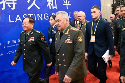 China's powerful vice chairman of the Central Military Commission, Zhang Youxian (left), and Russian Defense Minister Sergei Shoigu arrive for the Beijing Xiangshan Forum in the Chinese capital on Monday.