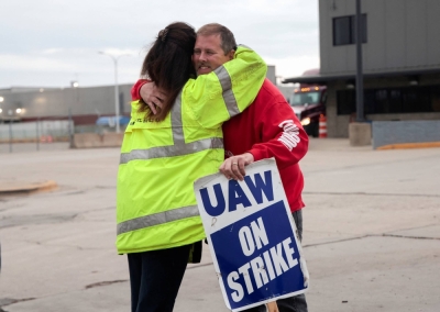 Striking United Auto Workers union members embrace at the end of their picket shift outside the Ford Assembly Plant in Wayne, Michigan, on Wednesday.