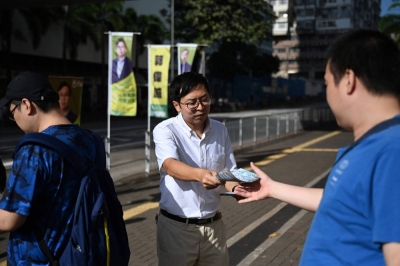Kwok Wai-shing (center) canvasses for votes to compete for a seat in the Sham Shui Po East constituency in Hong Kong's coming district council poll. Candidates from Hong Kong's main pro-democracy party were shut out of upcoming local elections after the nomination period ended on Monday.