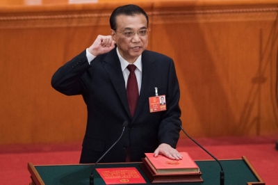 Then-Chinese Premier Li Keqiang takes the oath after he was re-elected for a second term during the sixth-plenary session of the National People's Congress in Beijing in March 2018.