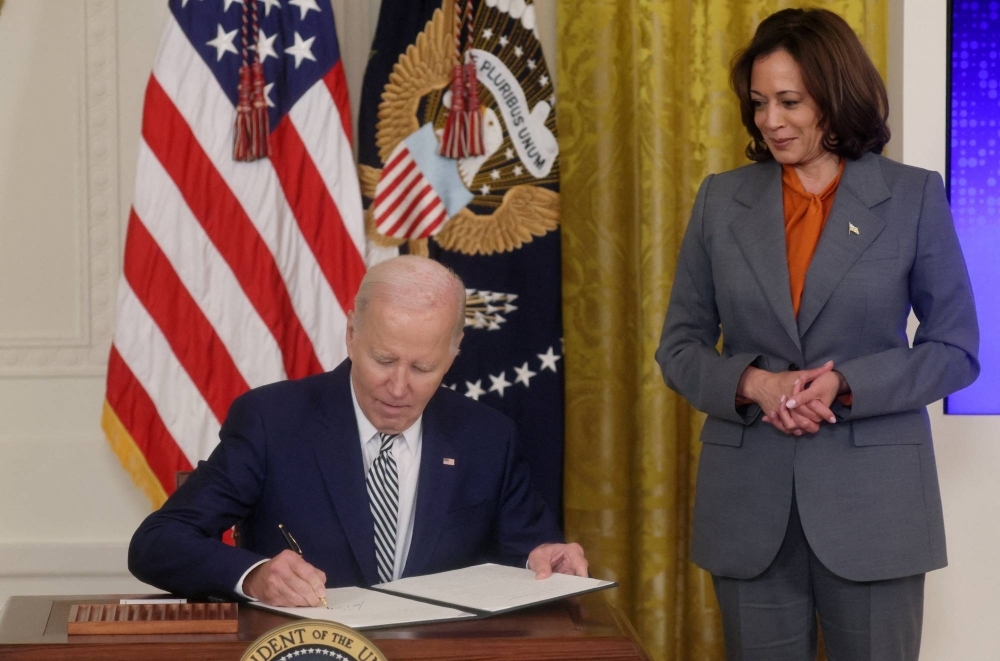 U.S. President Joe Biden signs an Executive Order about Artificial Intelligence as Vice President Kamala Harris looks on, at the White House in Washington on Monday.