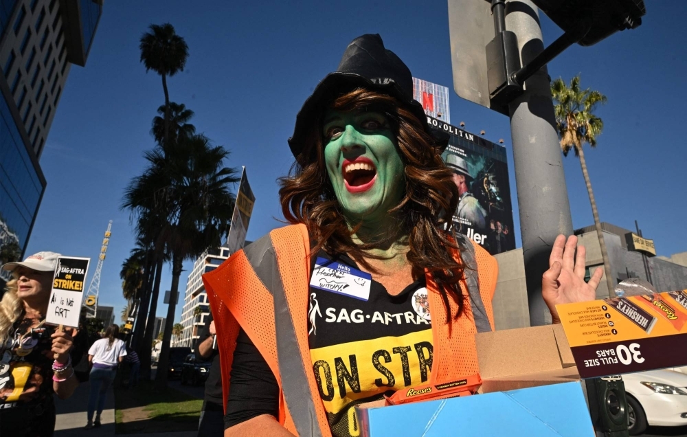 Members of the Screen Actors Guild-American Federation of Television and Radio Artists dress in costume for Halloween as they walk the picket line outside Netflix Studios in Hollywood, California, on Oct. 31.