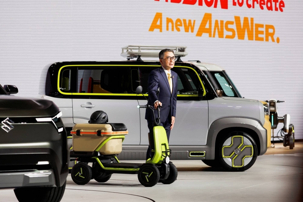 Suzuki President and Representative Director Toshihiro Suzuki unveils the Suzu-Ride at a press day of the Japan Mobility Show at Tokyo Big Sight in Tokyo on Oct. 25.