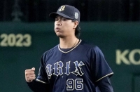 Buffaloes reliever Yuki Udagawa pumps his fist after striking out Tigers shortstop Seiya Kinami in the eighth inning of Orix's 5-4 win in Game 3 of the Japan Series on Tuesday at Koshien Stadium. | KYODO
