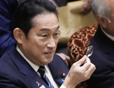 Prime Minister Fumio Kishida holds his glasses during an Upper House Budget Committee session in Tokyo on Wednesday.