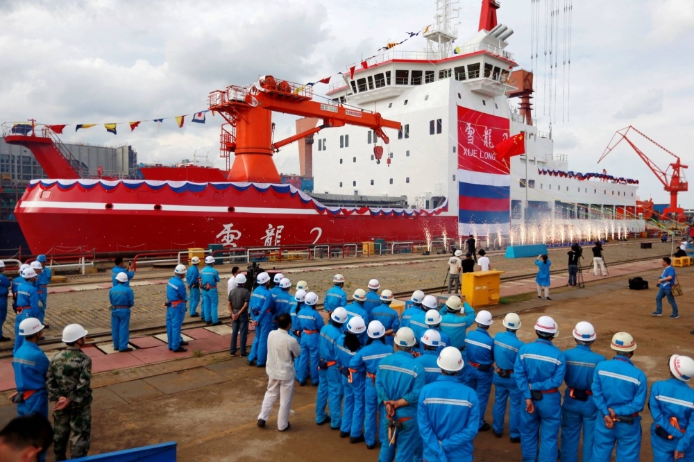 People attend the launch ceremony of China's first domestically built polar icebreaker Xuelong 2, or Snow Dragon 2, at a shipyard in Shanghai in 2018.