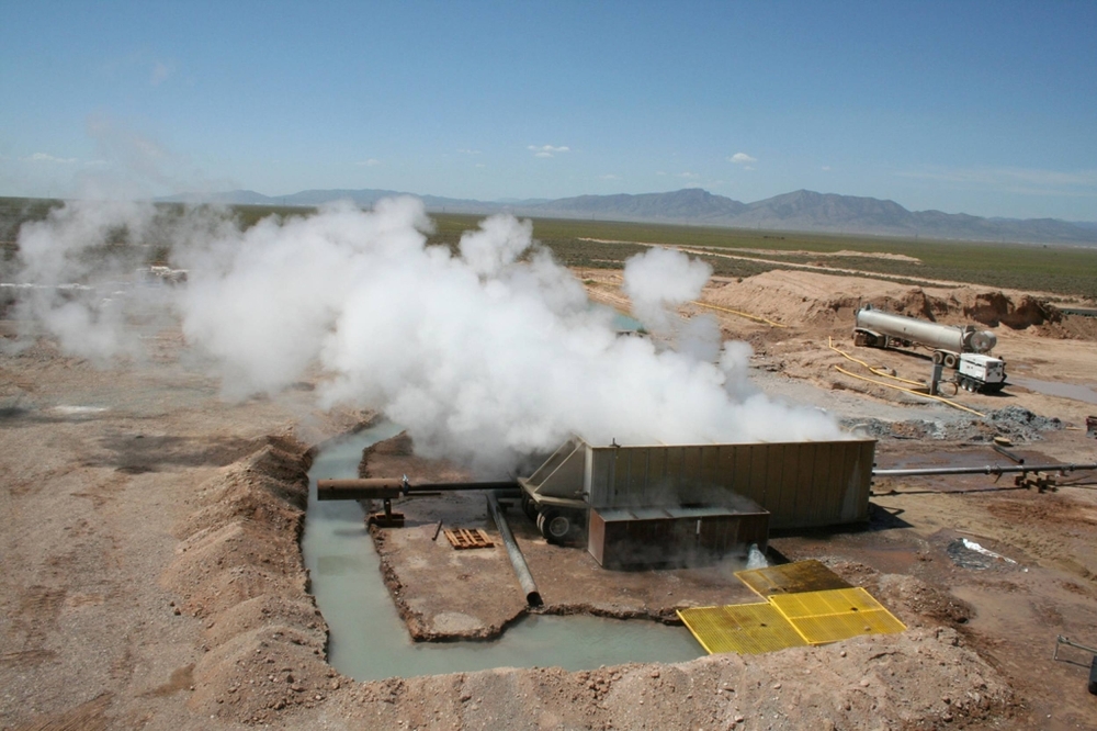 Steam escapes from a well at Raser Technologies' geothermal plant near Minersville, Utah. In April, the U.S. Department of Energy announced the first-ever backing for 11 community geothermal projects in 10 states, while several states have passed new laws to boost the strategy.
