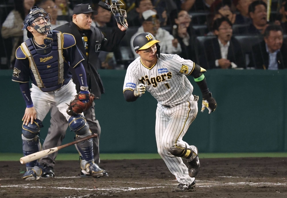 Tigers rookie Shota Morishita hits a two-run triple to left against the Buffaloes in the eighth inning in Game 5 of the Japan Series at Koshien Stadium in Nishinomiya, Hyogo Prefecture, on Thursday.