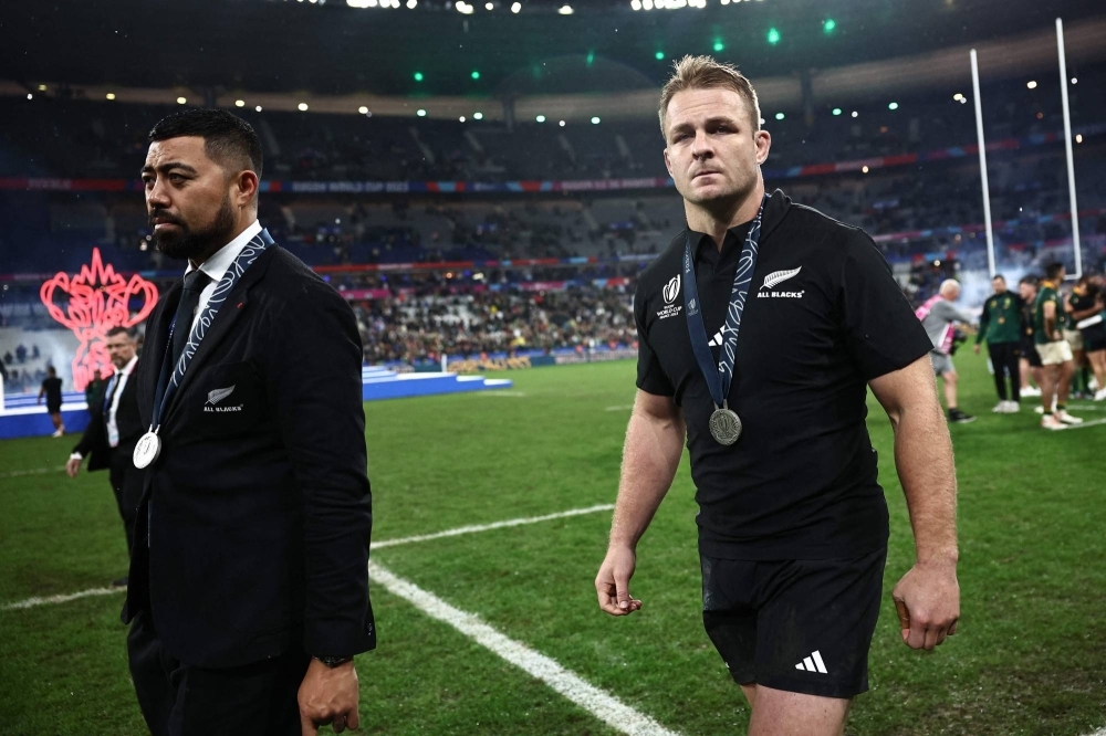 New Zealand's openside flanker and captain Sam Cane (right) walks on the field with his silver medal after South Africa won the France 2023 Rugby World Cup final against New Zealand in Saint-Denis, France, on Sunday.