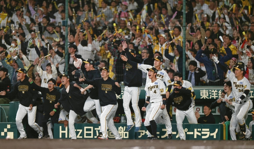 Hanshin players celebrate Morishita's come-from-behind two-run triple