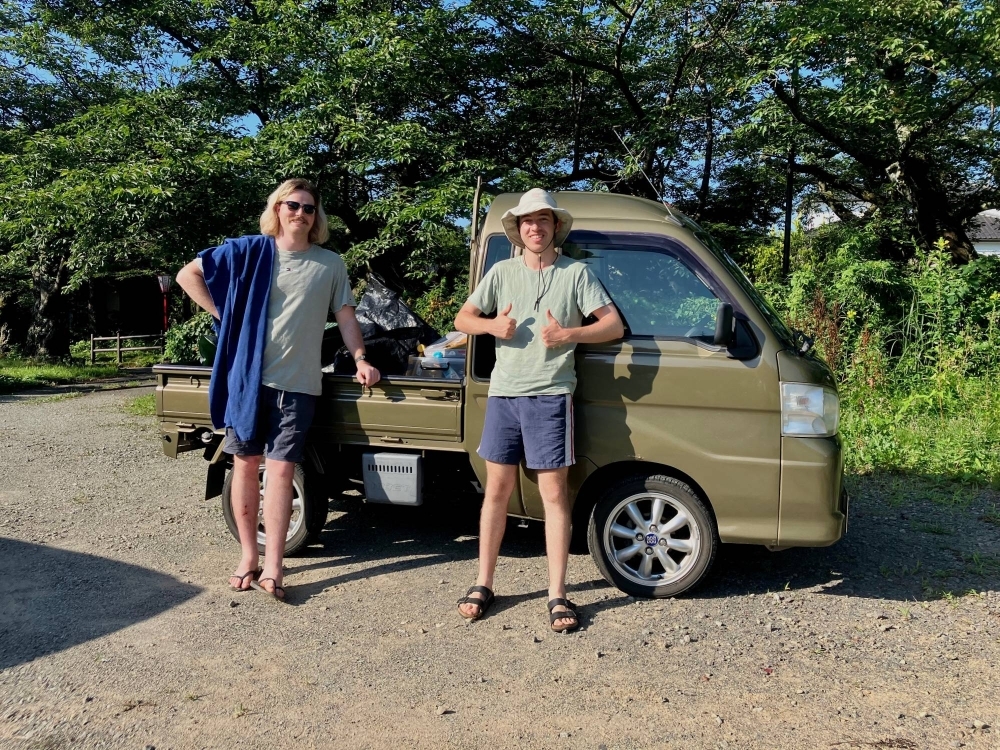 Blair Masters and Talisker Scott Hunter pose for a photo with their kei truck, nicknamed “KT,” outside Ebisu Circuit in Fukushima Prefecture.