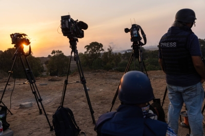 Members of the international press gather on a hill in Sderot, Israel, with a view of the Gaza Strip, on Oct. 28.