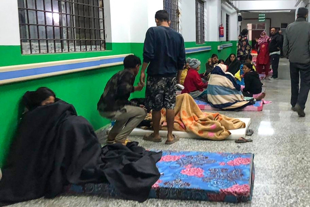 Survivors are seen in a corridor of the Jajarkot district hospital in the aftermath of an earthquake in Jajarkot, Nepal, on Saturday.