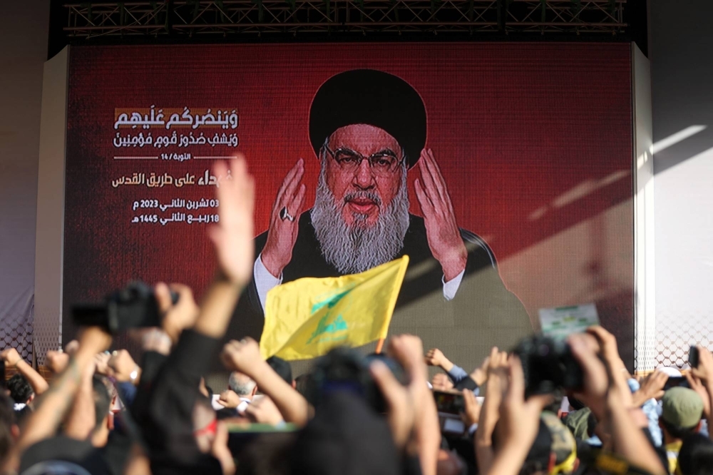 Lebanon's Hezbollah leader Hassan Nasrallah appears on a screen as he addresses his supporters during a ceremony to honor fighters killed in the recent fighting with Israel, in Beirut's southern suburbs on Friday.
