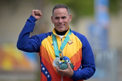 Venezuela's Leonel Martinez poses on the podium with his silver medal after the men's trap final shooting event at the Pan American Games in Santiago on Oct. 27. 