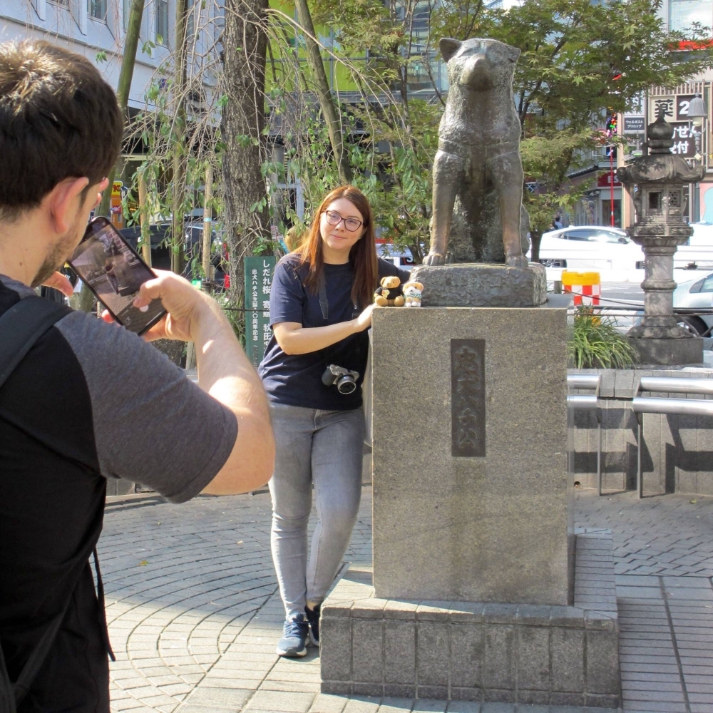 A tourist takes a photo with the statue of Hachiko in front of Shibuya Station in Tokyo on Wednesday.