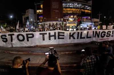 Journalists and activists call for justice and protection of media workers during a rally following the killing of a radio journalist in Quezon City, Philippines, in October 2022.  