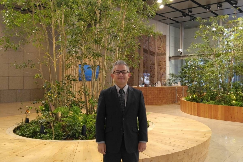 Motosaburo Saito at the headquarters of Oji Holdings, a building that won the Wood Design Award