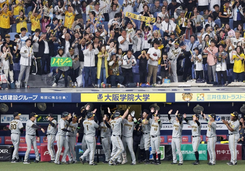 The Tigers' Sheldon Neuse (center, No. 7) celebrates with his teammates following his three-run homer in the fourth inning of Game 7 of the Japan Series against the Buffaloes at Kyocera Dome Osaka on Sunday.