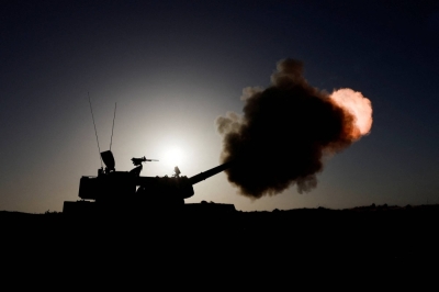 An Israeli military unit fires from an undisclosed location near the Gaza Strip border on Monday. 