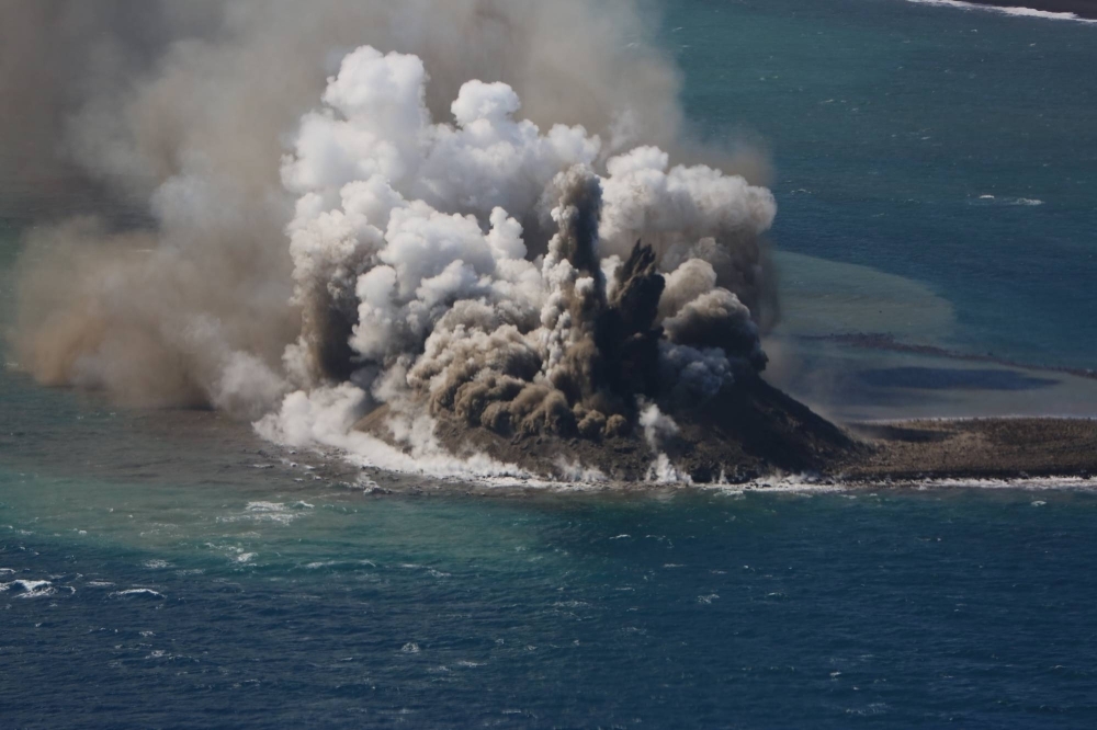 Plumes of smoke rise from a new isle after a recent volcano on Iwo Jima on Nov. 3.