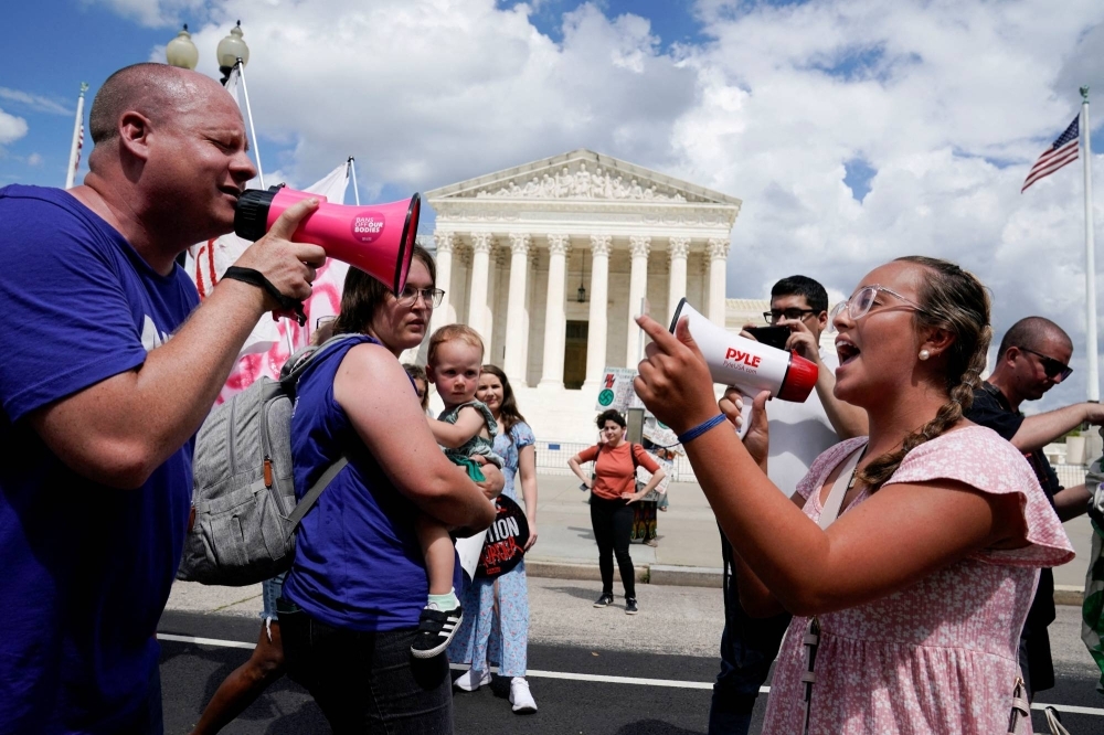 Abortion rights activists and counterprotesters demonstrate outside the U.S. Supreme Court in June on the first anniversary of the court ruling in the Dobbs vs. Women’s Health Organization case, overturning the landmark Roe v. Wade abortion decision. 