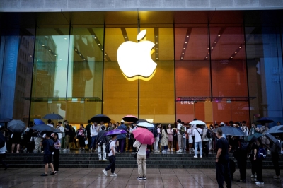 People stand outside an Apple Store in Shanghai as the new iPhone 15 officially goes on sale across China on Sept. 22.