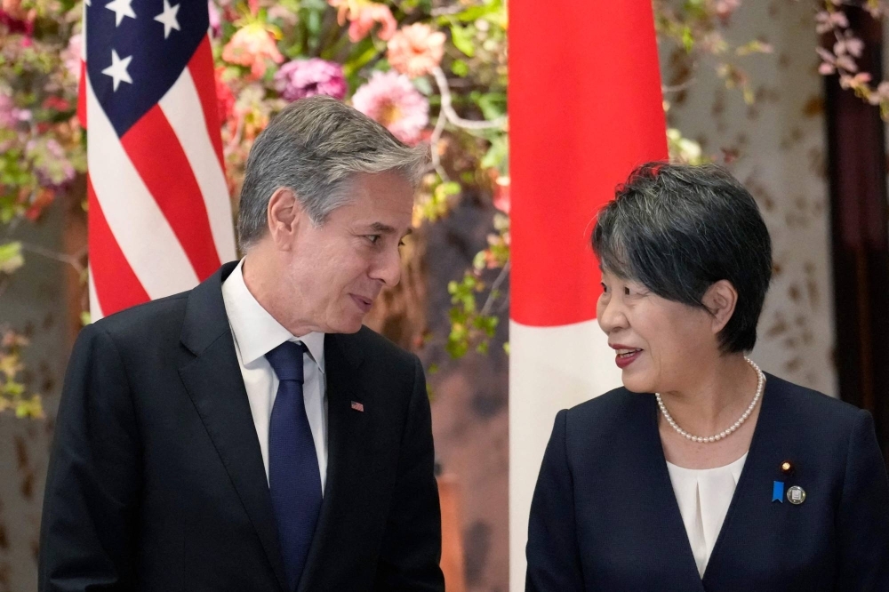 U.S. Secretary of State Antony Blinken (left) and Japan's Foreign Minister Yoko Kamikawa speak during G7 foreign ministers' meetings in Tokyo on Wednesday. Blinken plans to fly to Seoul after the meetings conclude.