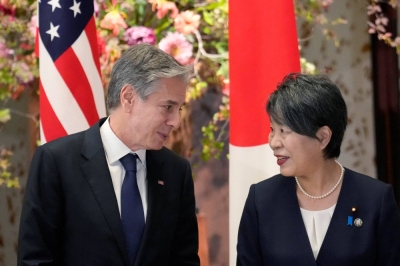 U.S. Secretary of State Antony Blinken and Foreign Minister Yoko Kamikawa speak as they wait for a group photo session during the Group of Seven foreign ministers meeting in Tokyo on Wednesday.