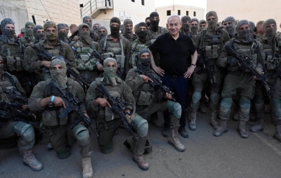Israeli Prime Minister Benjamin Netanyahu poses for a photo with soldiers as he visits an Israeli army base in Tze'elim, Israel, on Tuesday.