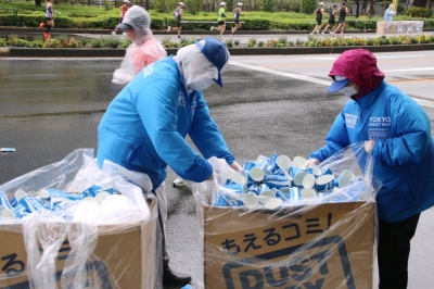 Staff at the Tokyo Legacy Half Marathon 2023 collect used paper cups after the event on Oct. 15.