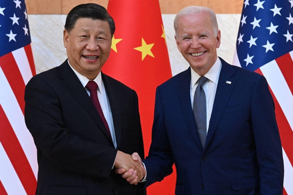 U.S. President Joe Biden and Chinese President Xi Jinping shake hands as they meet on the sidelines of the G20 Summit in Nusa Dua on the Indonesian resort island of Bali on Nov. 14, 2022.
