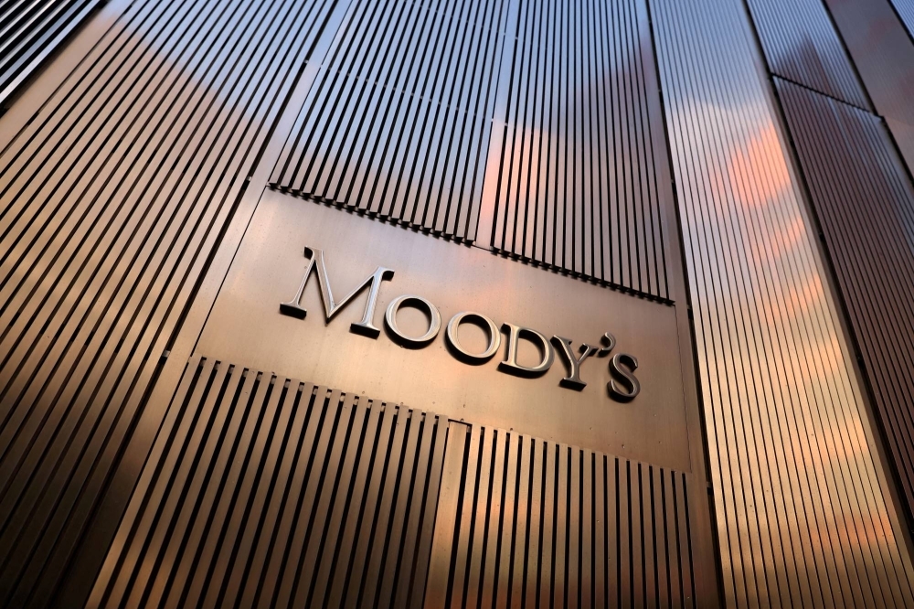 Federal spending and political polarization prompted Moody's on Friday to lower its outlook on the U.S. credit rating to "negative" from "stable." 