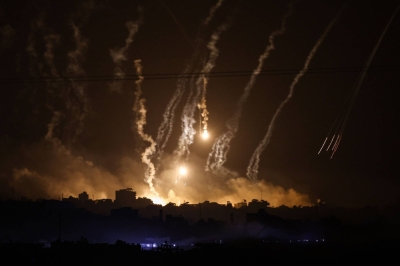 Smoke and flares dropped by Israeli forces over the Gaza Strip is seen amid ongoing battles between Israel and Palestinian Hamas militants on Friday.