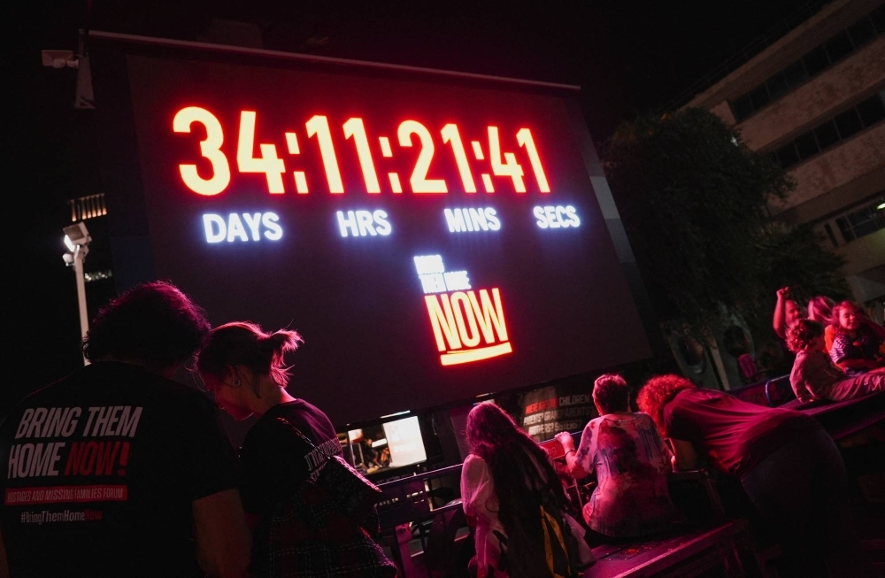 A screen displays the amount of time Israeli hostages have been held by Hamas militants since they were abducted on Oct. 7, at an event marking the Jewish Sabbath held for families, friends and supporters, in Tel Aviv on Friday.