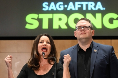 SAG-AFTRA President Fran Drescher speaks as she is flanked by Duncan Crabtree-Ireland, SAG-AFTRA's executive director and chief negotiator, during a news conference following the end of the Screen Actors Guild strike in Los Angeles on Friday.