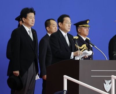 Prime Minister Fumio Kishida delivers a speech as Defense Minister Minoru Kihara looks on at the Air Self-Defense Force's Iruma Air Base in Saitama Prefecture on Saturday.