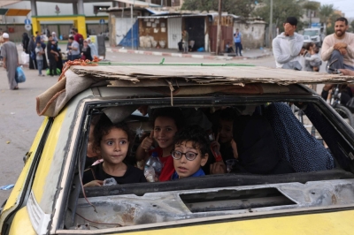 Palestinians arrive in Khan Yunis in the southern Gaza Strip on Saturday after fleeing their homes in Gaza City and the northern Gaza Strip amid ongoing fighting between Israel and Hamas militants.