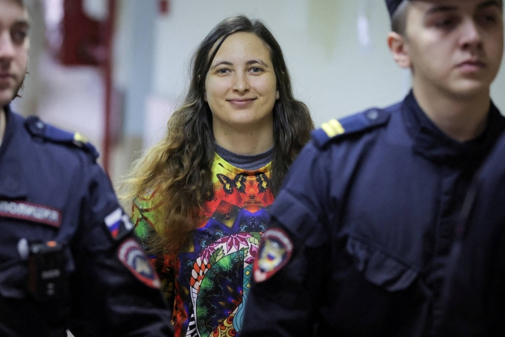 Alexandra Skochilenko, a 33-year-old artist charged with spreading false information about Russia's armed forces, is escorted during a court hearing in St. Petersburg on Nov. 8.