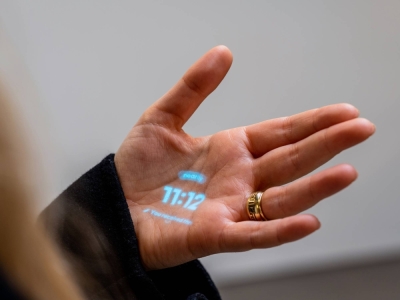 The Humane Ai Pin’s interface is projected onto the hand of company co-founder Bethany Bongiorno in San Francisco on Oct. 27. Humane, a company started by two former Apple employees, says its new artificial intelligence pin can stop all the scrolling.