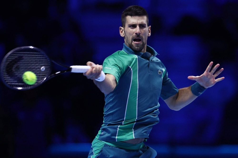 Novak Djokovic hits a return against Holger Rune during their match at the ATP Finals in Turin, Italy, on Sunday.