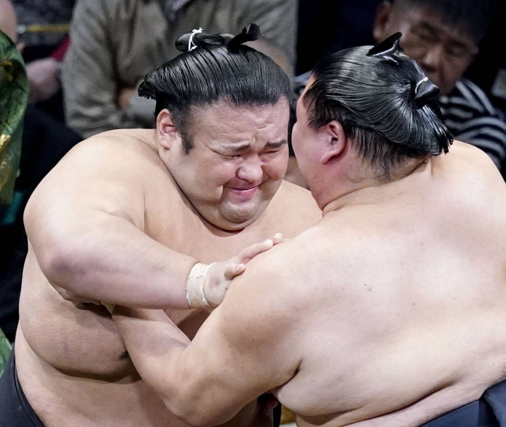 Ozeki Takakeisho (left) battles Shodai on Day 2 of the Kyushu Grand Sumo Tournament in Fukuoka on Monday.