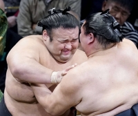 Ozeki Takakeisho (left) battles Shodai on Day 2 of the Kyushu Grand Sumo Tournament in Fukuoka on Monday. | KYODO