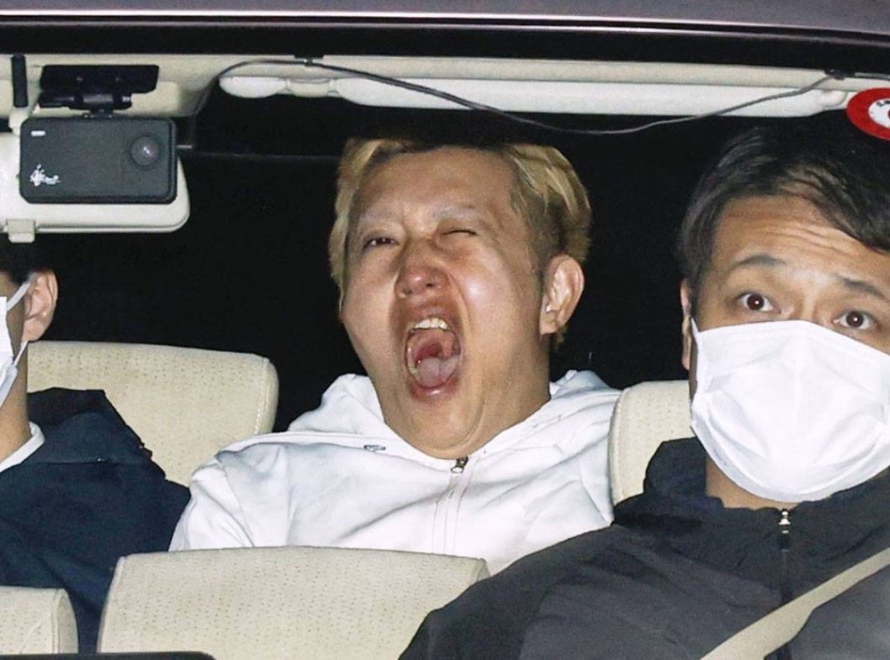 YouTuber Kazuaki Sugita in a police car in Tokyo on Monday night after being arrested for allegedly slandering a woman