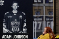A memorial for former Nottingham Panthers player Adam Johnson on Nov. 4 in Nottingham, England.  | Reuters