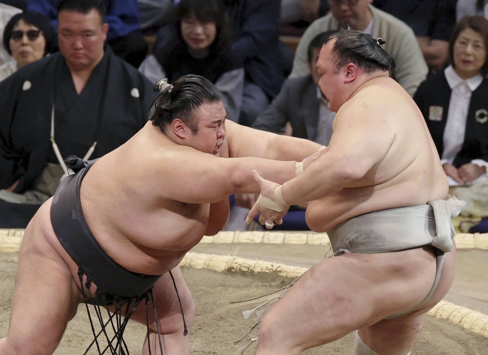 Takakeisho (left) wins his opening-day bout on Sunday in Fukuoka. The Hyogo Prefecture native is nearing a promotion to yokozuna. 
