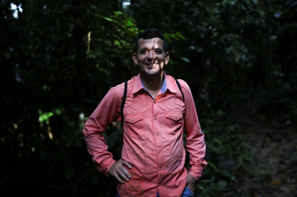 Jorge Santofimio, environmentalist and former guerrilla and signatory of the peace agreement between the Revolutionary Armed Forces of Colombia (FARC) and the Colombian government, poses for a photo during a day of searching for seeds to reforest the jungles, in Puerto Guzman, Colombia, in February 2022.