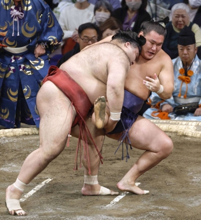 Takayasu (left) beats Hoshoryu on Day 6 of the Kyushu Grand Sumo Tournament in Fukuoka on Friday.