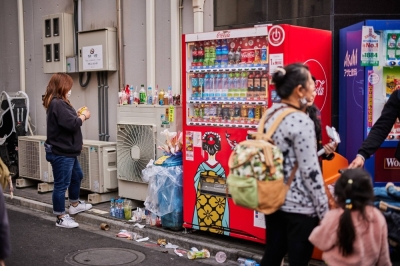 Overflowing trash next to a vending machine in the Asakusa district of Tokyo, which is popular with tourists, in March