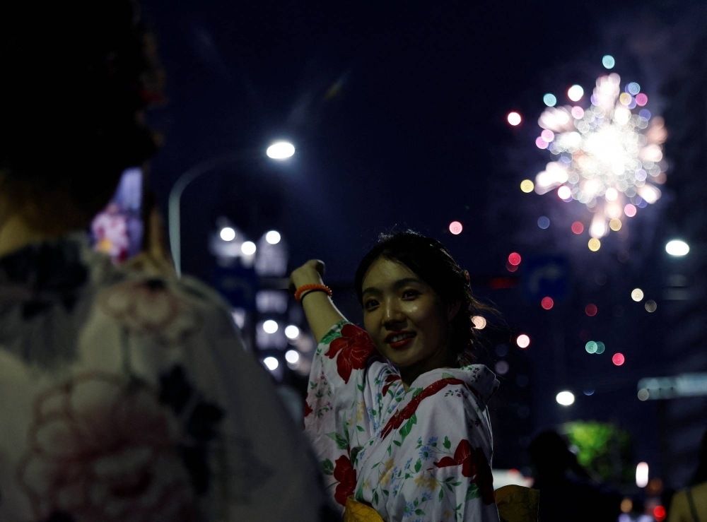 A woman wearing yukata at the Sumida River fireworks festival in Tokyo in July. 